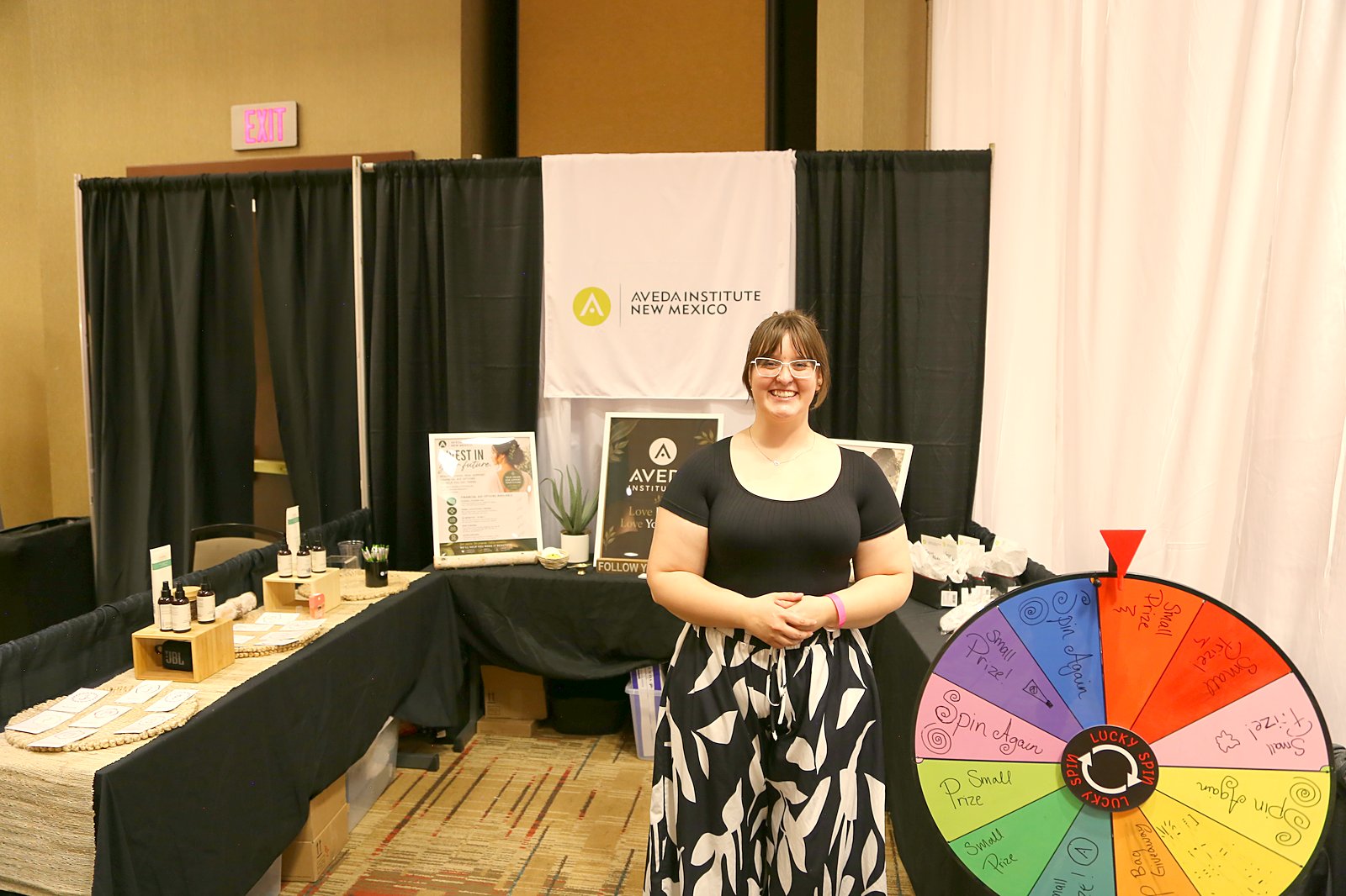Aveda Institute New Mexico booth with prize wheel at the New Mexico Wedding Expo
