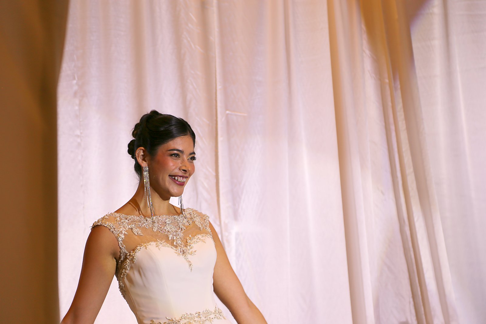Bridal model with elegant updo and soft glam makeup by Aveda Institute New Mexico students